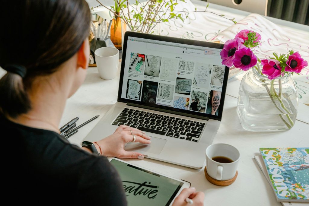 person sitting at a laptop with a cup of coffee