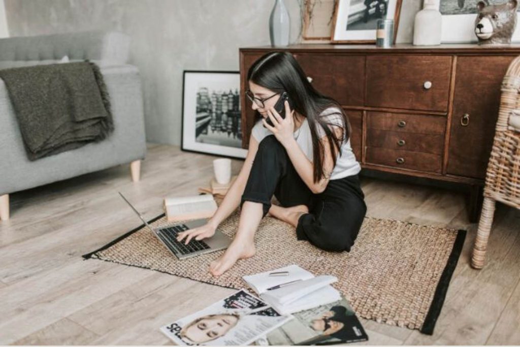 woman sitting on the floor working from home 