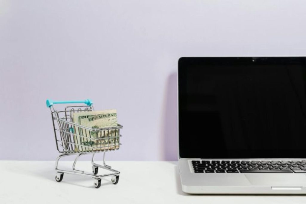 small shopping cart next to computer