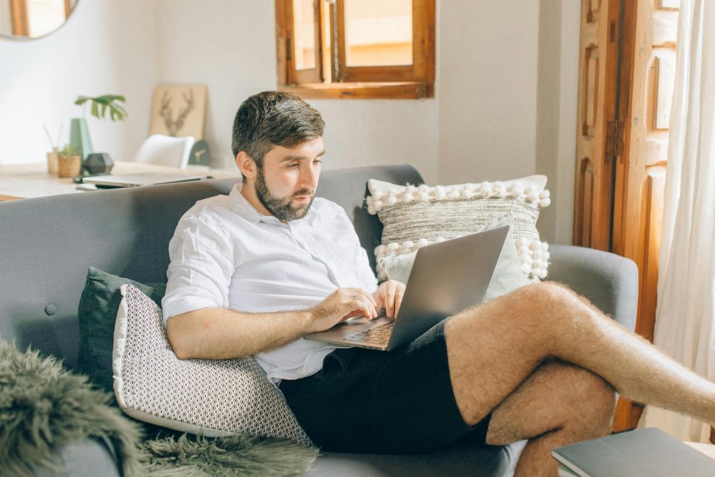 man working from home on couch