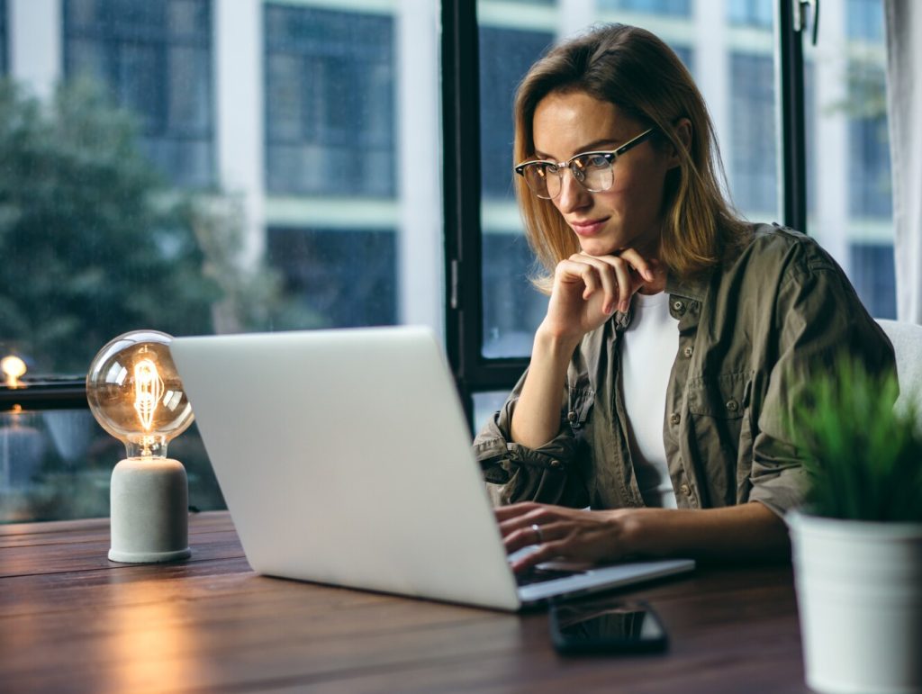Young woman working with a laptop. Female freelancer.