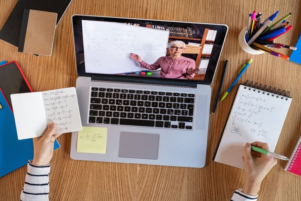 person watching a tutorial on the screen of a personal laptop