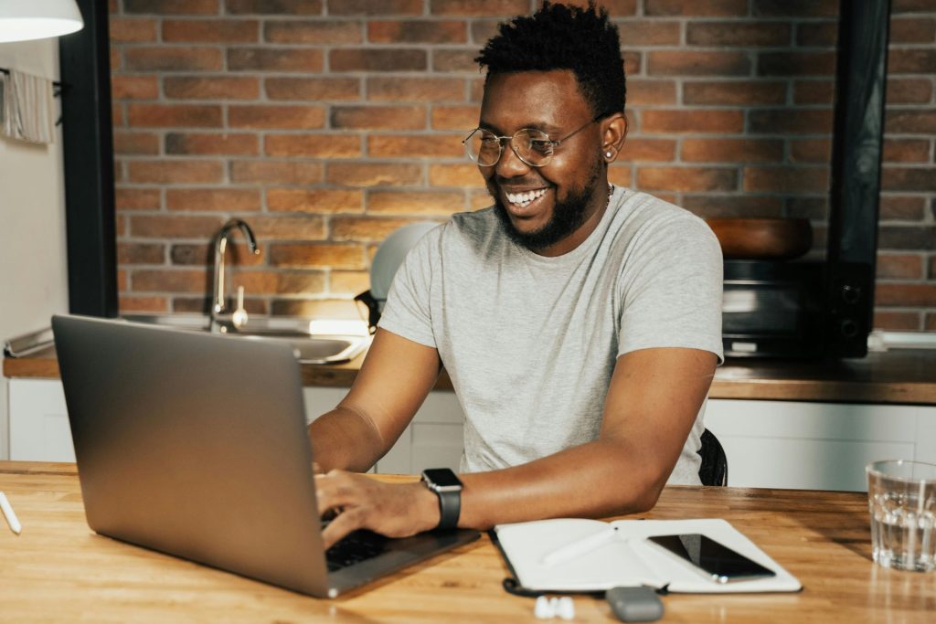 smiling man working on a computer 