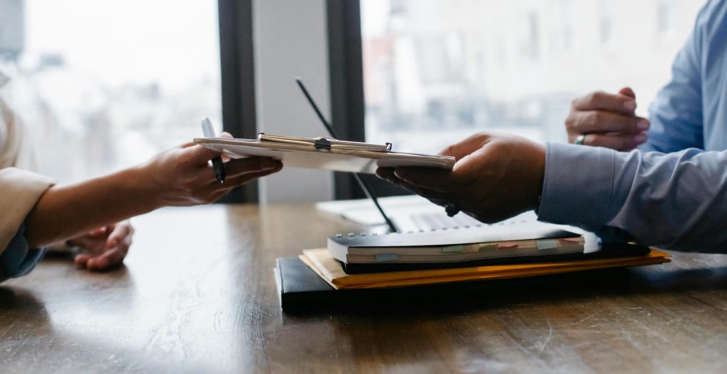proofreader candidate passing resume to hr employee