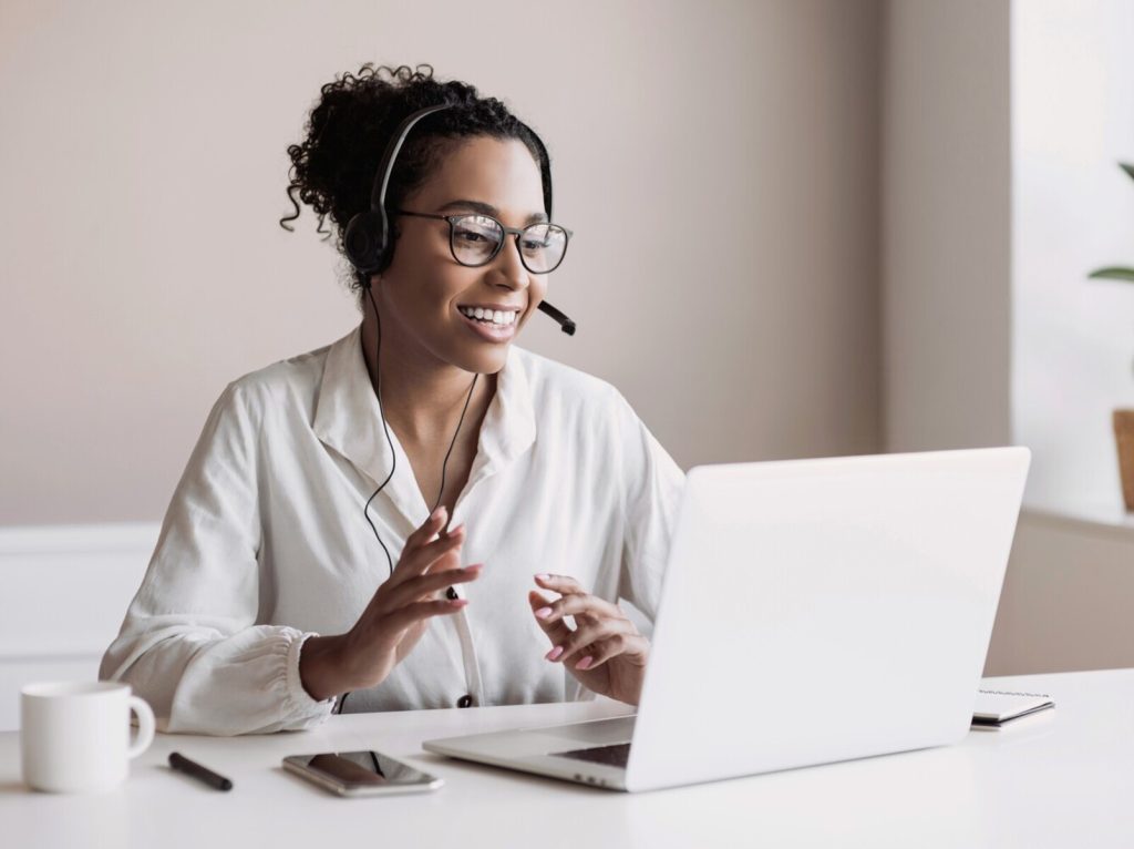 Woman with headset working online in a video meeting