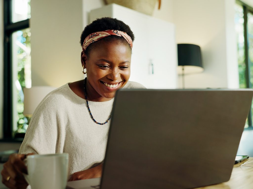 Remote work, black woman or happy with laptop in home for editor feedback, blog review and coffee. Freelancer, journalist or tech in house for newsletter research, proofreading article and planning