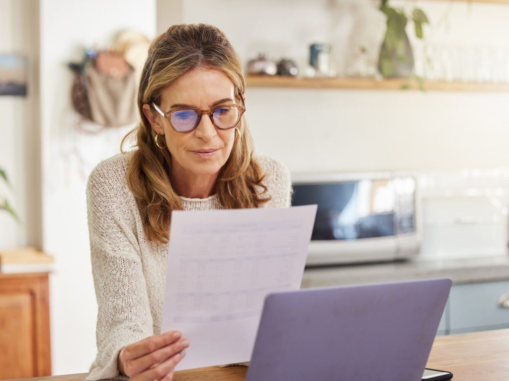 woman with laptop and paperwork