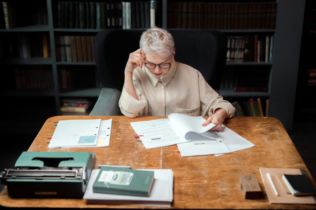woman sitting at a desk proofreading