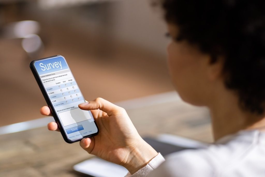 woman taking a survey on a cell phone
