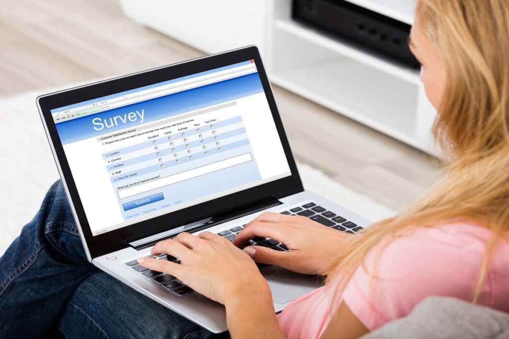 woman taking an online survey on a laptop